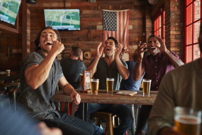 Group of male friends celebrating Super Bowl 2025