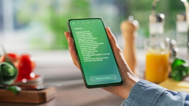 Hand holding a smartphone with an AI interface with a recipe