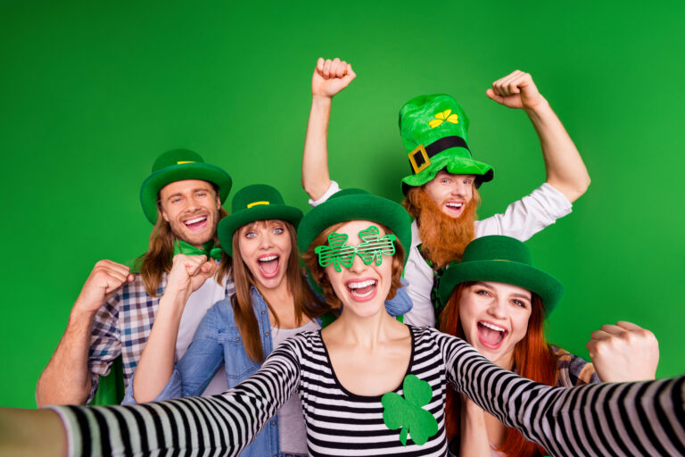 People cheerfully bonding, taking a self portrai representing celebration of St Patrick's day
