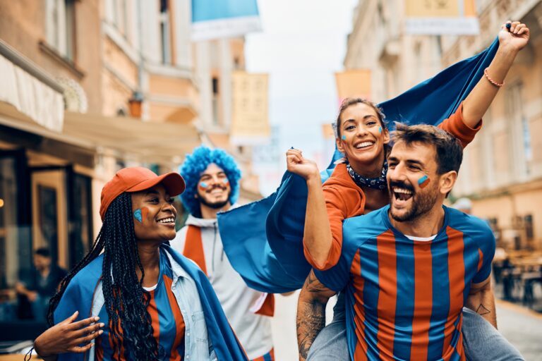 Group of young football fans cheering