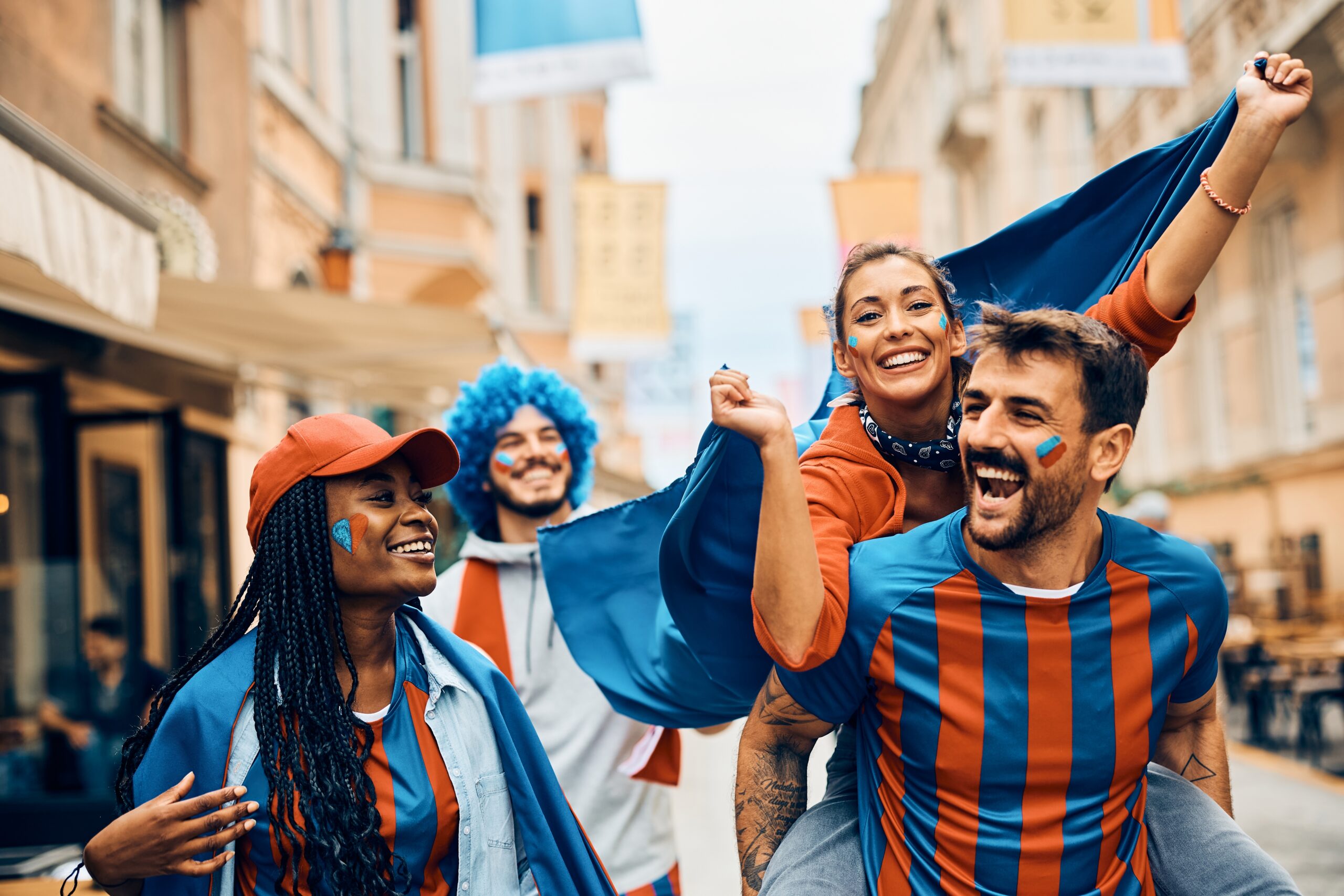 Group of young football fans cheering