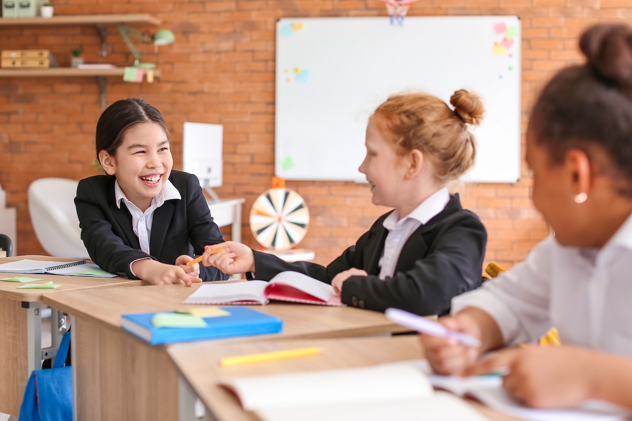 Cute little pupils during lesson at school